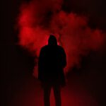 silhouette of person on a dark place with smoke